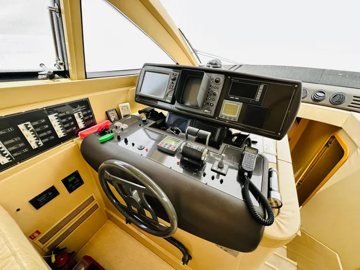  Yacht Photos Pics Cockpit of 2005 Ferretti Yachts 550, featuring navigation controls and steering wheel.