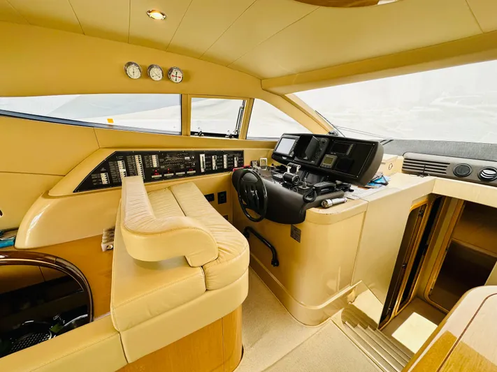  Yacht Photos Pics 2005 Ferretti Yachts 550 helm with beige interior and advanced navigation controls.