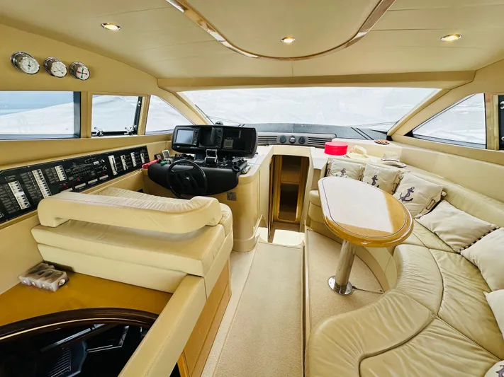 Yacht Photos Pics Luxurious interior of a 2005 Ferretti Yachts 550 with plush seating and modern controls.