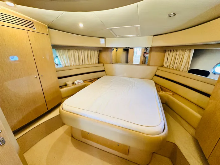  Yacht Photos Pics Luxurious cabin interior of a 2005 Ferretti Yachts 550 with a spacious bed.