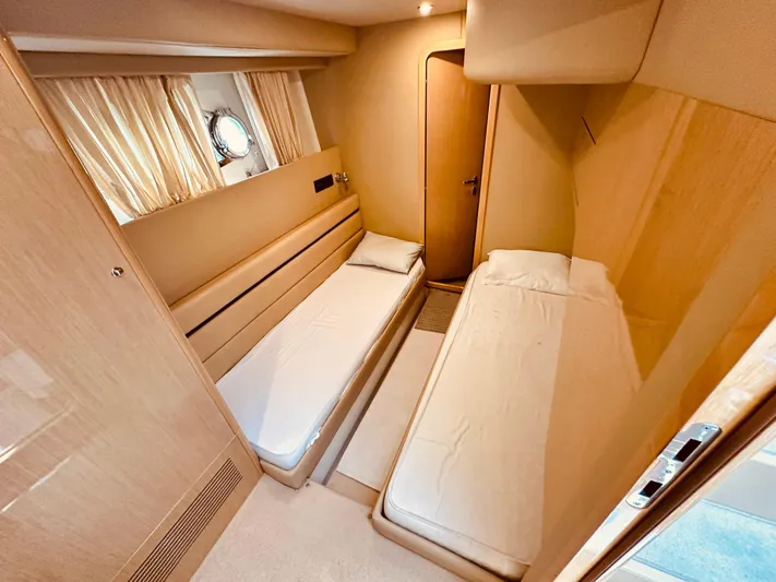  Yacht Photos Pics Twin cabin interior of 2005 Ferretti Yachts 550, featuring modern design and cozy beds.