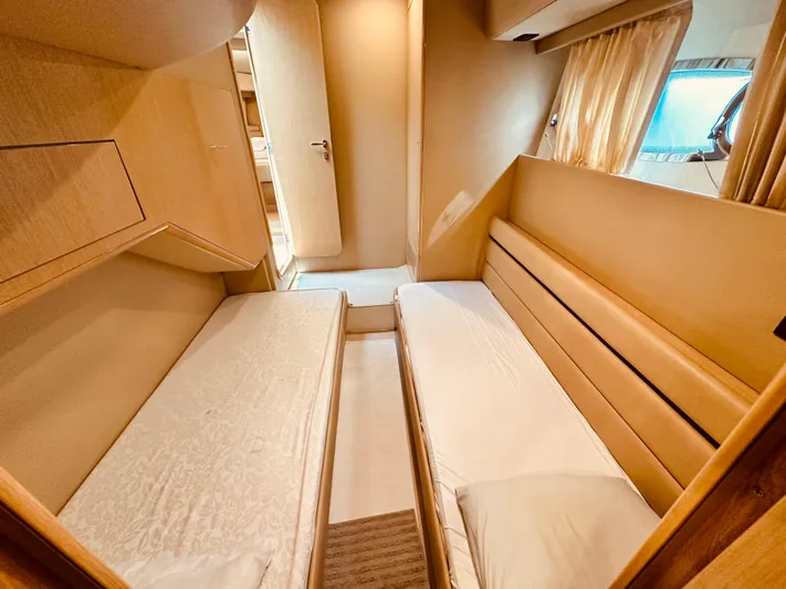 Yacht Photos Pics Twin cabin interior of 2005 Ferretti Yachts 550 with cozy beds and window.