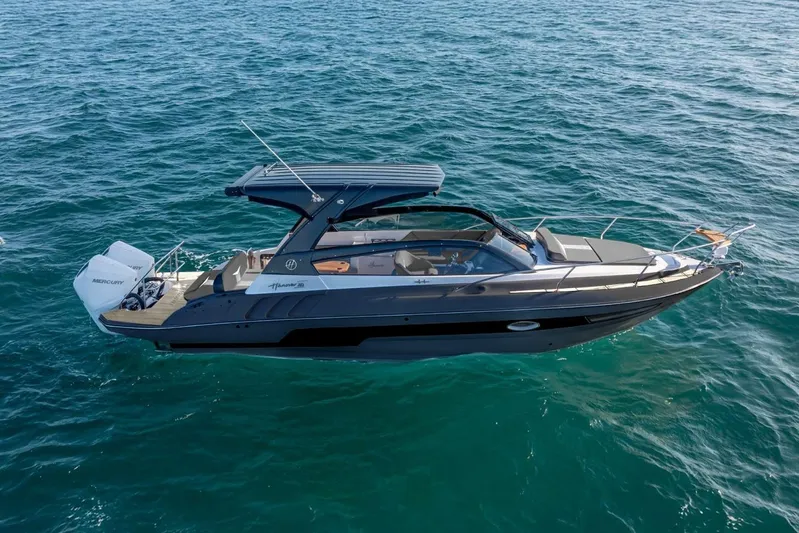  Yacht Photos Pics 2025 Hanover 305 Gray & Black Edition boat cruising on clear blue water.