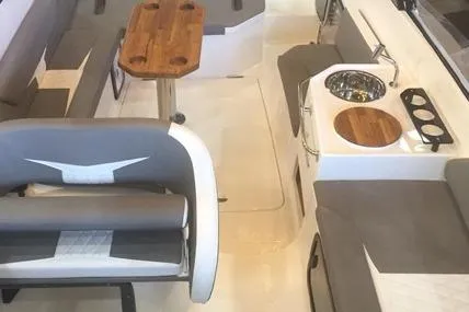  Yacht Photos Pics Interior of 2025 Hanover 305 Gray & Black Edition boat with seating and kitchenette.