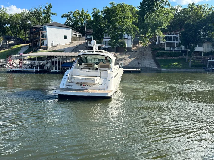  Yacht Photos Pics 2013 Sea Ray 410 Sundancer yacht on a serene lake near waterfront homes.