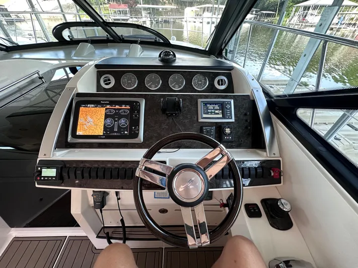  Yacht Photos Pics Cockpit of 2013 Sea Ray 410 Sundancer with navigation controls and steering wheel.