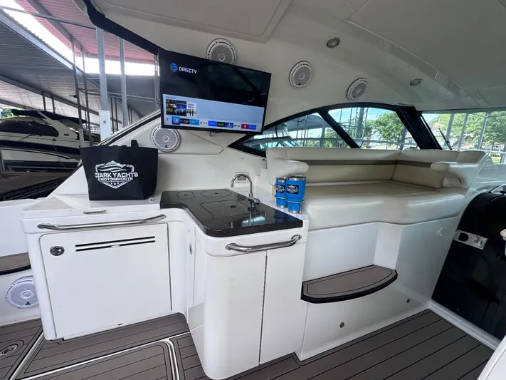  Yacht Photos Pics Luxurious interior of 2013 Sea Ray 410 Sundancer yacht with TV and seating area.