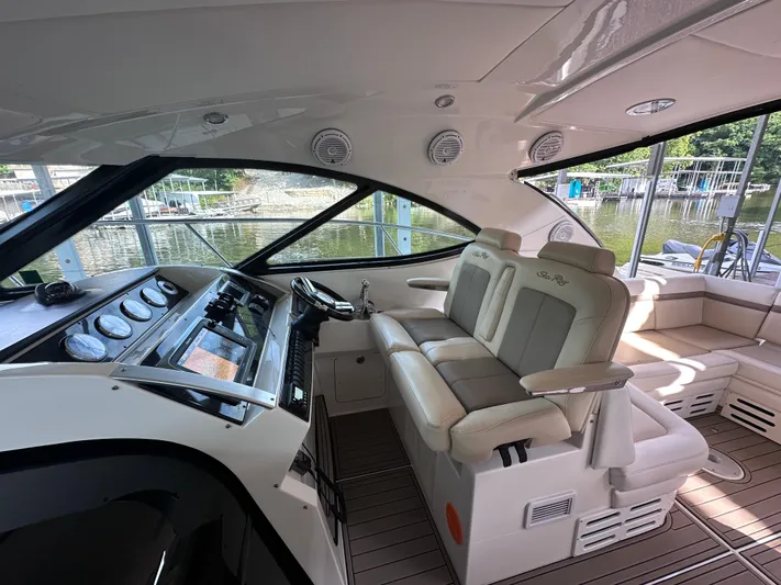  Yacht Photos Pics 2013 Sea Ray 410 Sundancer cockpit with luxurious seating and modern dashboard controls.
