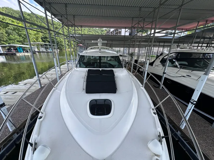  Yacht Photos Pics 2013 Sea Ray 410 Sundancer docked under covered marina with scenic lake view.