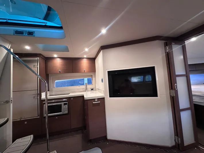  Yacht Photos Pics Interior of 2013 Sea Ray 410 Sundancer yacht with modern kitchen and entertainment area.