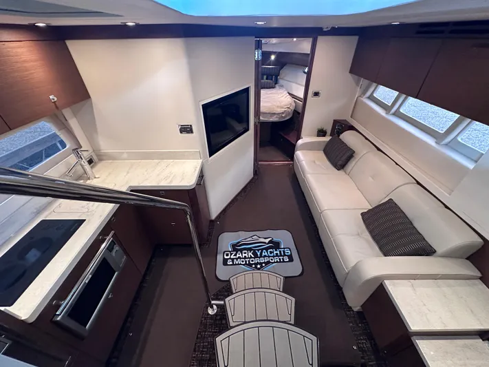  Yacht Photos Pics Luxurious interior of 2013 Sea Ray 410 Sundancer yacht with modern kitchen and seating area.