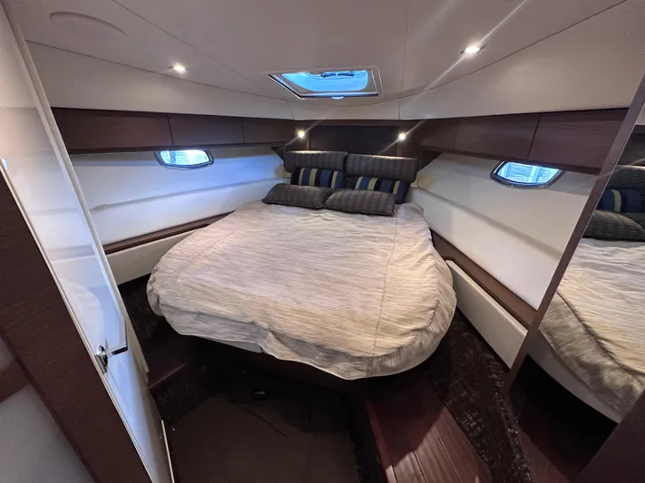  Yacht Photos Pics Luxurious cabin interior of 2013 Sea Ray 410 Sundancer yacht with cozy bed and modern design.