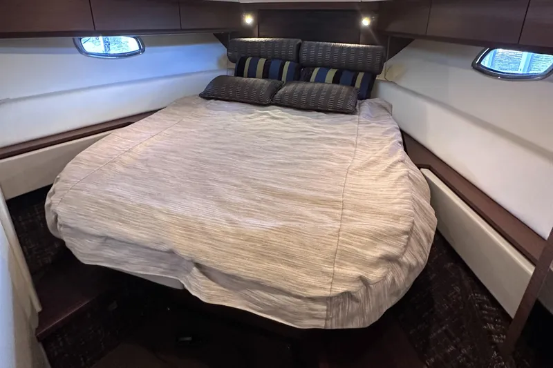  Yacht Photos Pics Luxurious cabin interior of 2013 Sea Ray 410 Sundancer with cozy bed and ambient lighting.