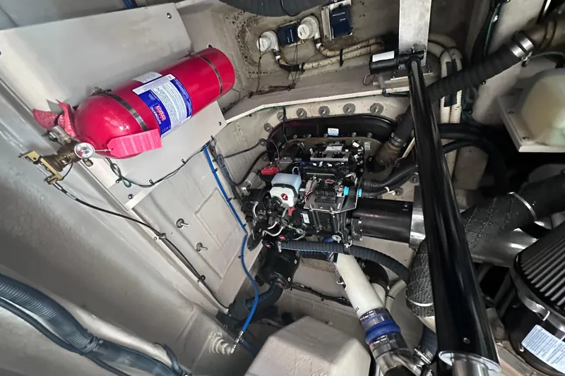  Yacht Photos Pics Engine room of 2013 Sea Ray 410 Sundancer with fire extinguisher and mechanical components.
