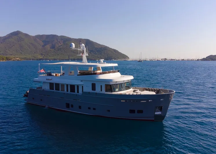  Yacht Photos Pics Custom 85 Semi Displacement Trawler yacht cruising in scenic coastal waters, 2022 model.