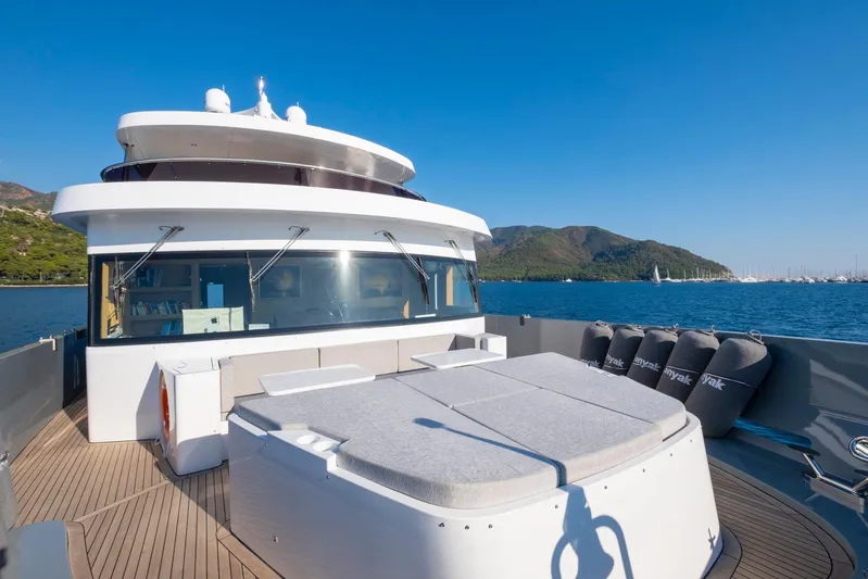  Yacht Photos Pics Custom 85 Semi Displacement Trawler 2022 on scenic water with mountains in background.