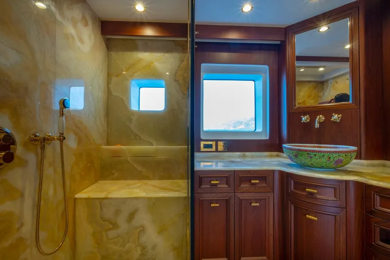  Yacht Photos Pics Luxurious bathroom on 2022 Custom 85 Semi Displacement Trawler with marble and wood finishes.