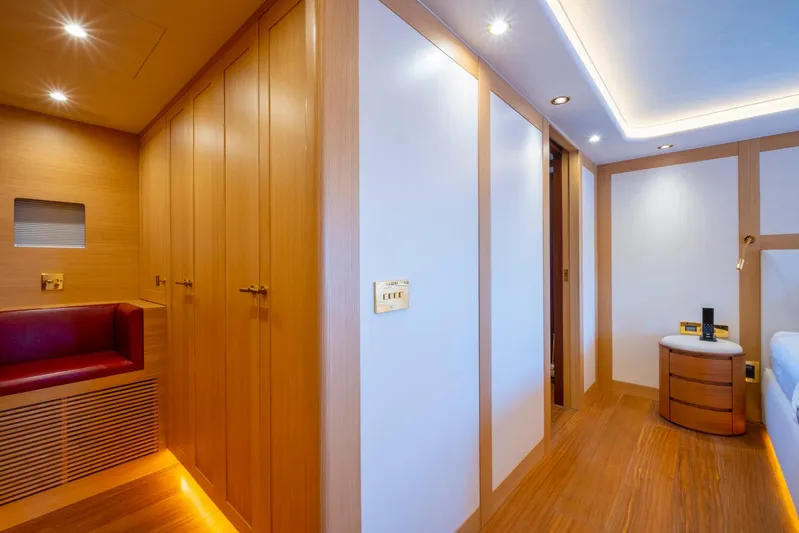  Yacht Photos Pics Luxurious interior of 2022 Custom 85 Semi Displacement Trawler with wood paneling and ambient lighting.