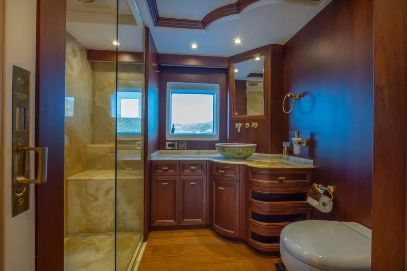  Yacht Photos Pics Luxurious bathroom on 2022 Custom 85 Semi Displacement Trawler with wood accents and modern fixtures.