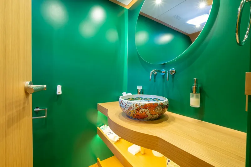  Yacht Photos Pics Luxurious bathroom on 2022 Custom 85 Semi Displacement Trawler with vibrant green walls and ornate sink.