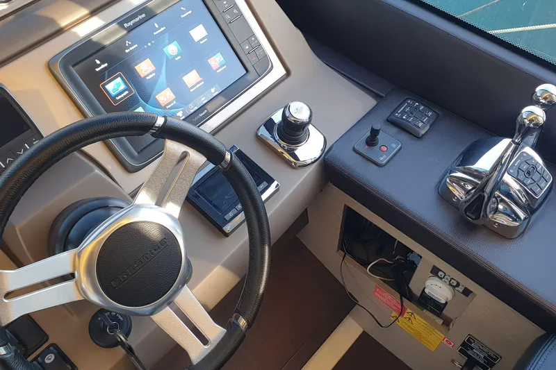 Jamap Yacht Photos Pics Cockpit of 2016 Prestige 550 Fly yacht with steering wheel and control panel.