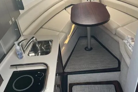  Yacht Photos Pics Interior of 2021 Monterey 295 Sport Yacht with kitchenette and seating area.