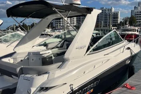  Yacht Photos Pics 2021 Monterey 295 Sport Yacht docked at marina with cityscape background.