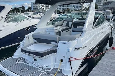  Yacht Photos Pics 2021 Monterey 295 Sport Yacht docked at marina, featuring sleek design and spacious seating.