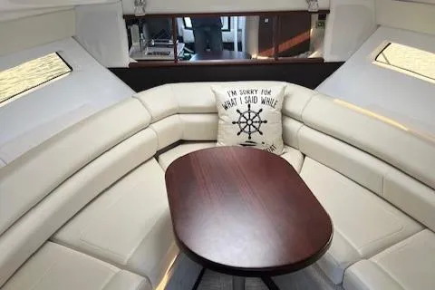  Yacht Photos Pics Luxurious interior of 2021 Monterey 295 Sport Yacht with plush seating and wooden table.