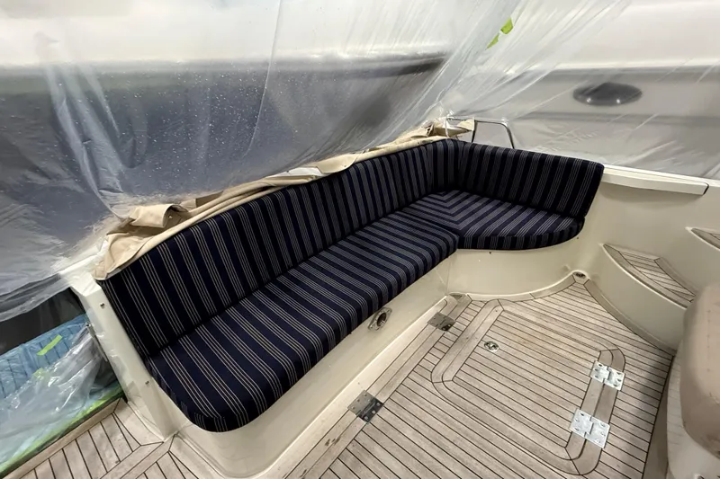 Bad Dog Yacht Photos Pics 2021 Sabre 42 Fly Bridge interior with striped seating and wooden flooring.