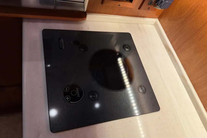 Bad Dog Yacht Photos Pics Kenyon cooktop on Sabre 42 Fly Bridge yacht, 2021 model, sleek black design.