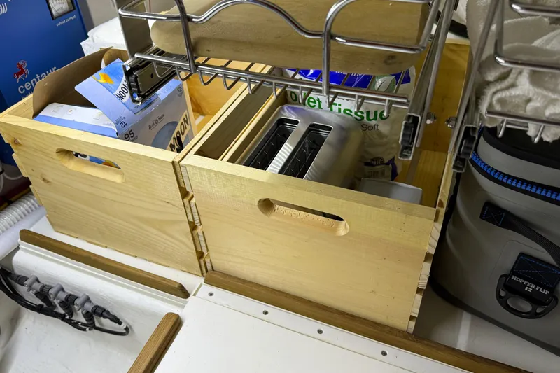 Bad Dog Yacht Photos Pics Wooden storage boxes with a toaster and supplies on a Sabre 42 Fly Bridge yacht.