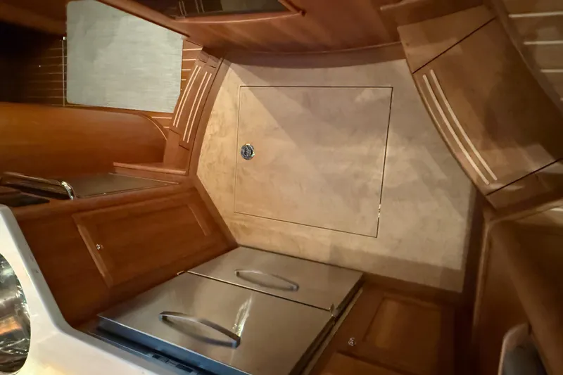 Bad Dog Yacht Photos Pics Interior of 2021 Sabre 42 Fly Bridge yacht with wooden cabinetry and stainless steel appliances.