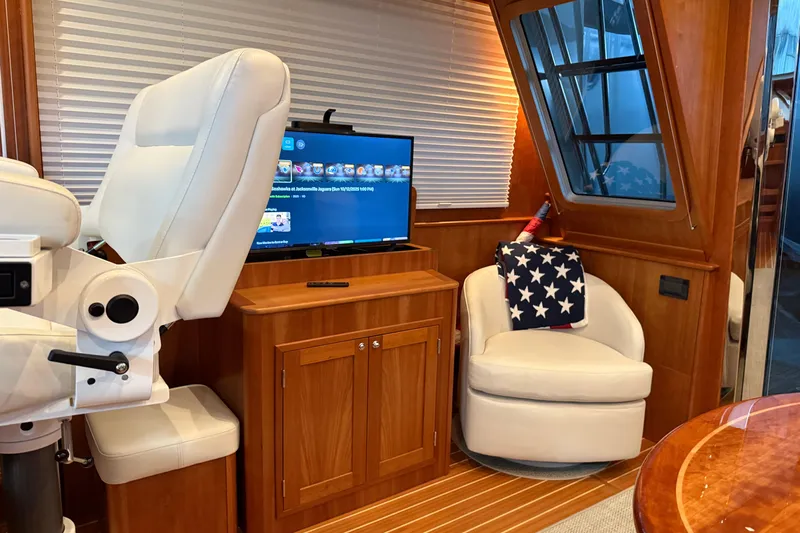 Bad Dog Yacht Photos Pics Luxurious interior of 2021 Sabre 42 Fly Bridge yacht with plush seating and entertainment system.