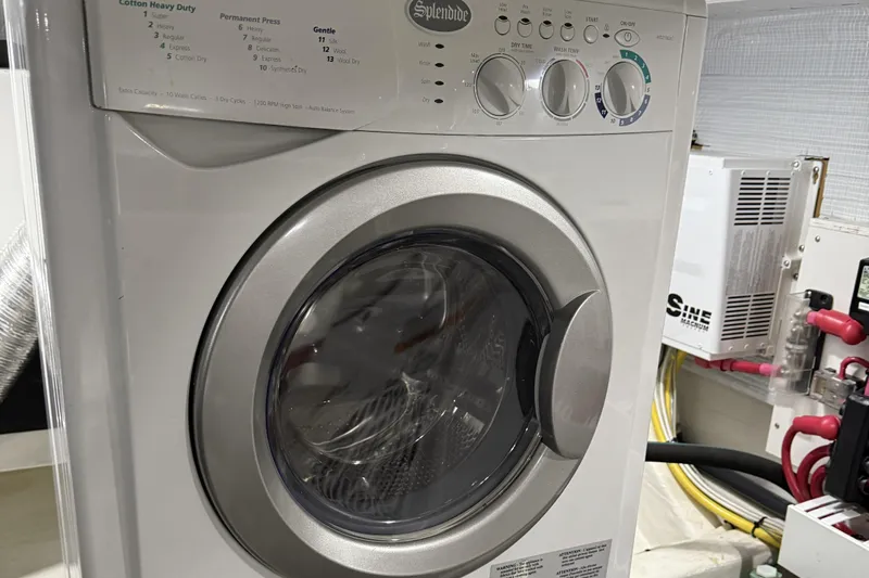 Bad Dog Yacht Photos Pics Front-loading washing machine in a 2021 Sabre 42 Fly Bridge yacht laundry area.