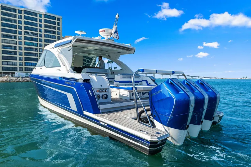 Yacht Photos Pics 2024 Formula 380 Super Sport Crossover boat on water, with blue exterior and triple Mercury engines.