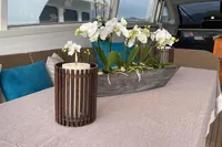 Luxurious interior of 1997 Arno Leopard 27m yacht with elegant decor and floral arrangement.
