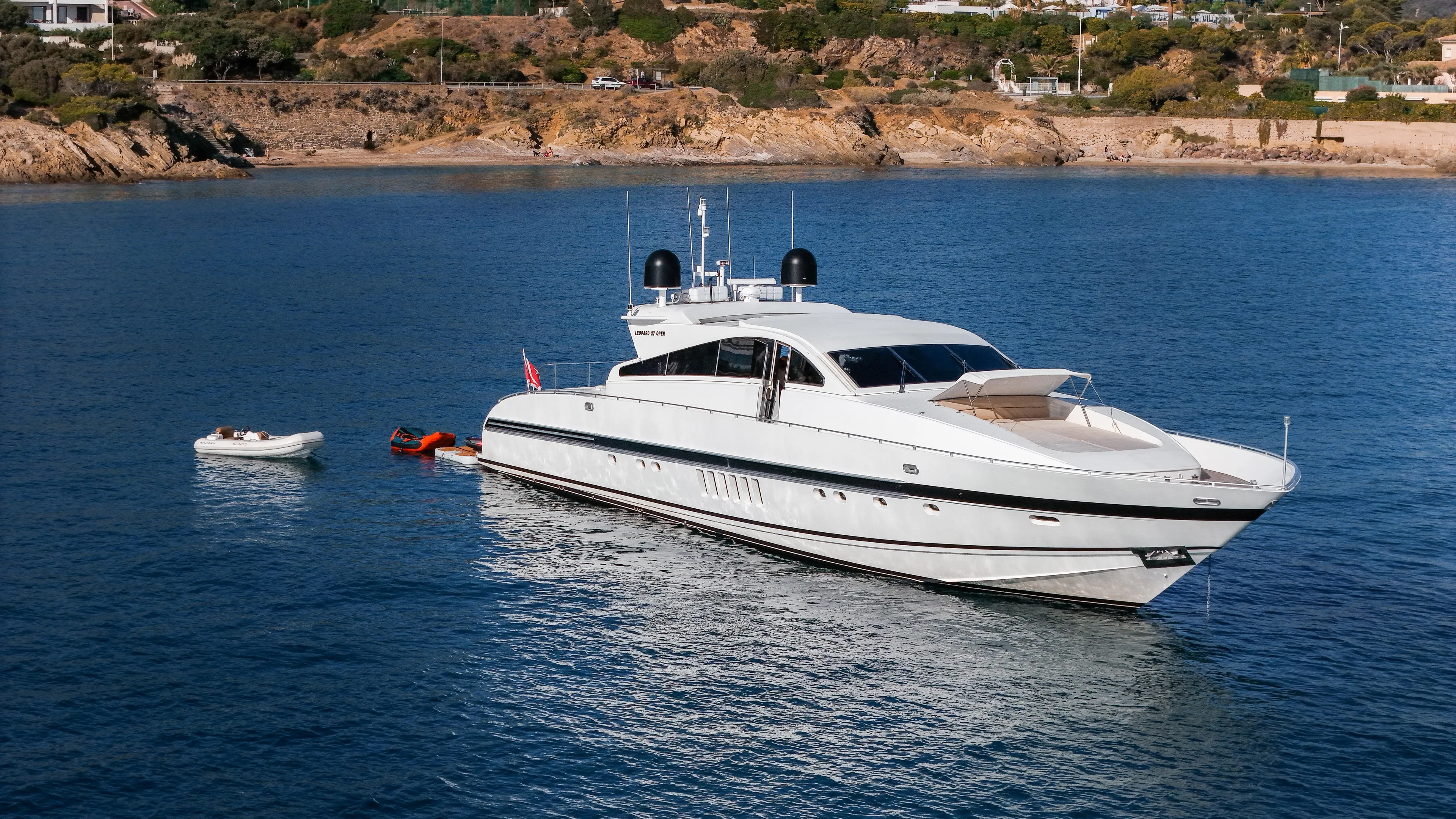 Luxurious 1997 Arno Leopard 27m yacht anchored in serene coastal waters.