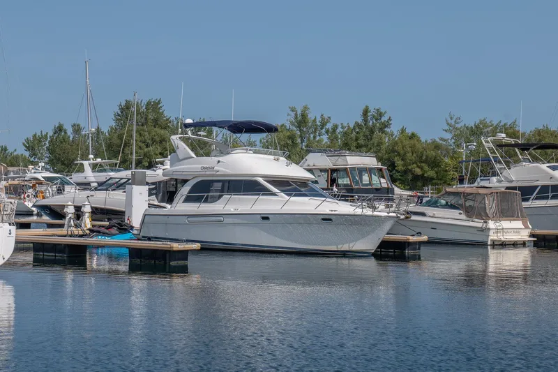  Yacht Photos Pics 2001 Bayliner 3788 Command Bridge Motoryacht docked in a marina, surrounded by other boats.