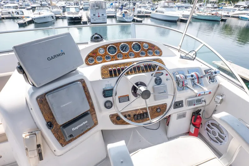  Yacht Photos Pics 2001 Bayliner 3788 Command Bridge Motoryacht helm with Garmin and Raymarine navigation systems.