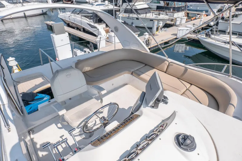  Yacht Photos Pics 2001 Bayliner 3788 Command Bridge Motoryacht with spacious helm and seating area at marina.