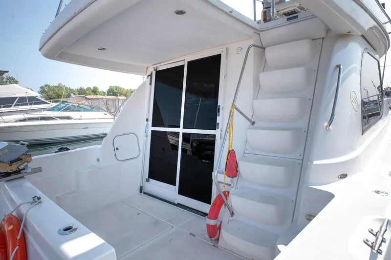  Yacht Photos Pics 2001 Bayliner 3788 Command Bridge Motoryacht, rear view with stairs and sliding door.