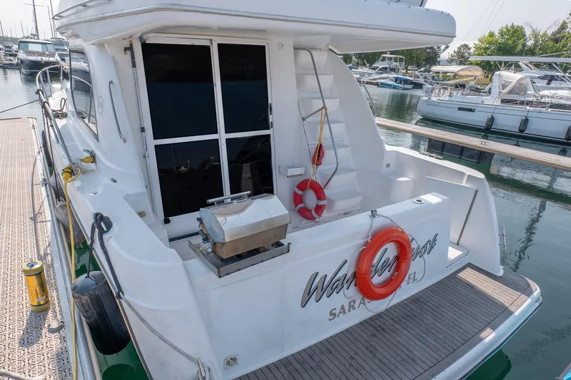  Yacht Photos Pics 2001 Bayliner 3788 Command Bridge Motoryacht docked, featuring rear deck and safety equipment.
