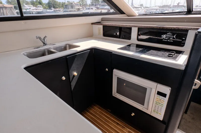  Yacht Photos Pics 2001 Bayliner 3788 Command Bridge Motoryacht kitchen with sink, stove, and microwave.