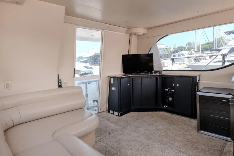  Yacht Photos Pics Interior of 2001 Bayliner 3788 Command Bridge Motoryacht with beige seating and TV.