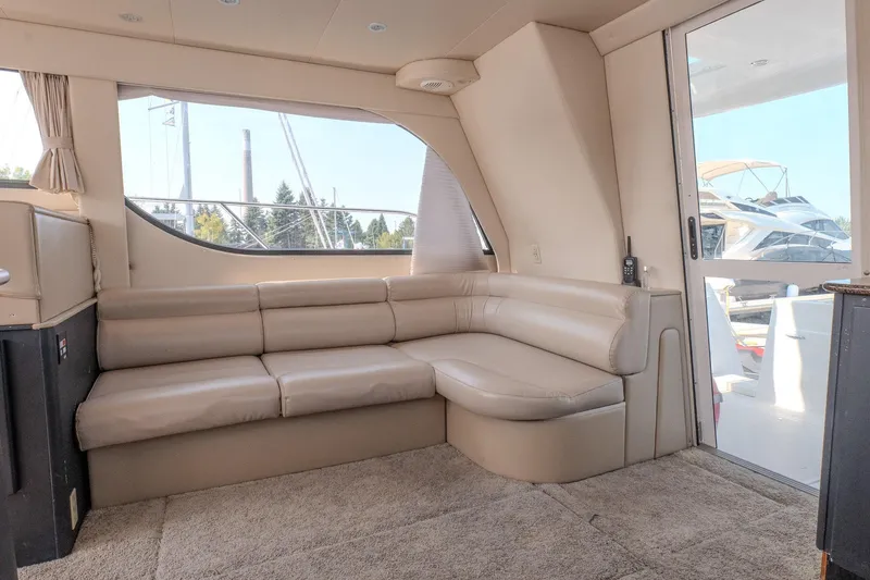  Yacht Photos Pics Interior of 2001 Bayliner 3788 Command Bridge Motoryacht with beige seating and large windows.