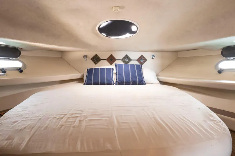  Yacht Photos Pics 2001 Bayliner 3788 Command Bridge Motoryacht cabin with bed and portholes.