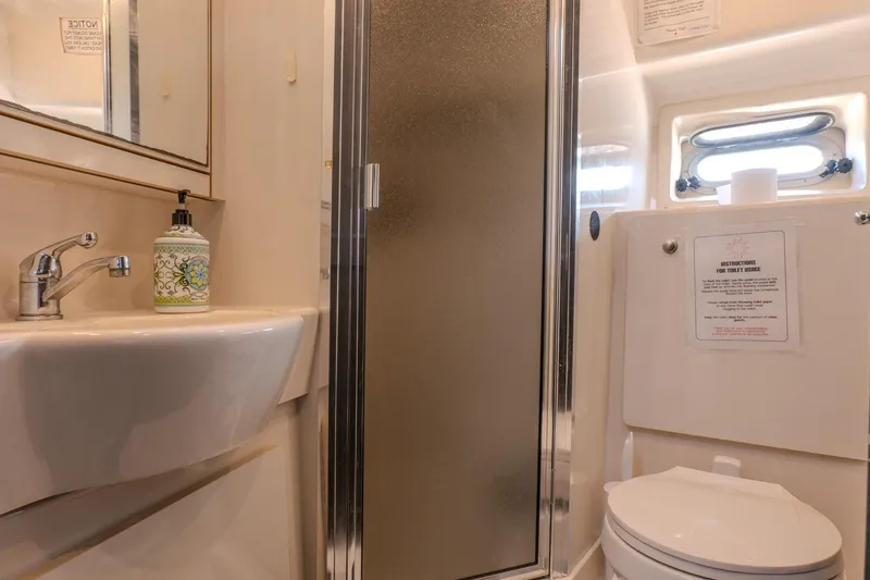  Yacht Photos Pics Bathroom interior of 2001 Bayliner 3788 Command Bridge Motoryacht with sink, shower, and toilet.