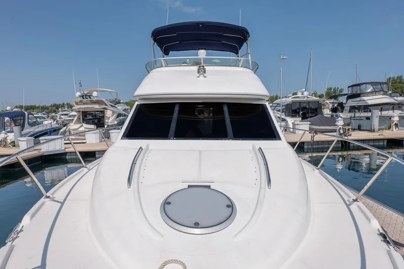  Yacht Photos Pics 2001 Bayliner 3788 Command Bridge Motoryacht docked at marina under clear blue sky.