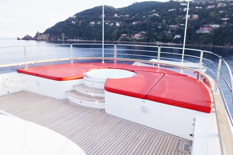 Euphoria II Yacht Photos Pics Luxurious Mayra Yachts 50m deck with red seating and jacuzzi, 2016 model, scenic coastal view.